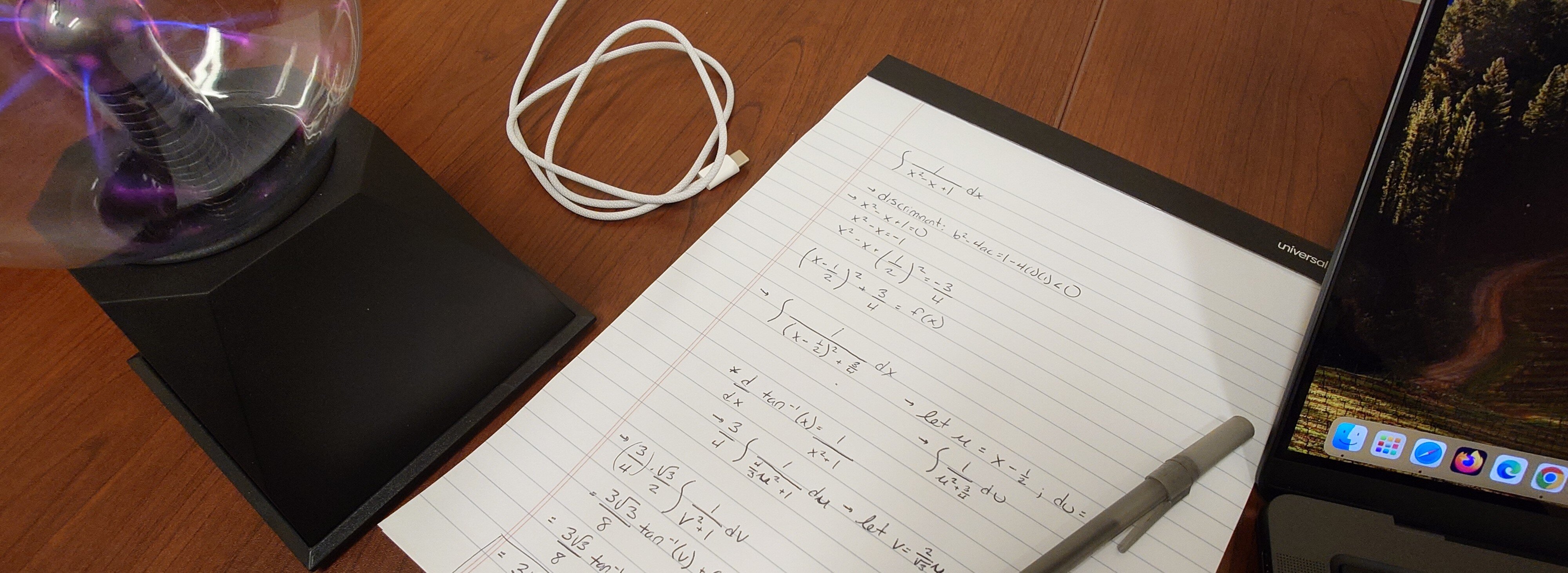 An image of a plasma ball, a sheet of paper with equations and a computer